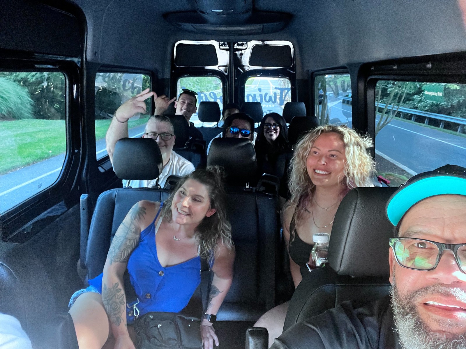 Happy passengers riding together inside the Twin Beach Tours Sprinter